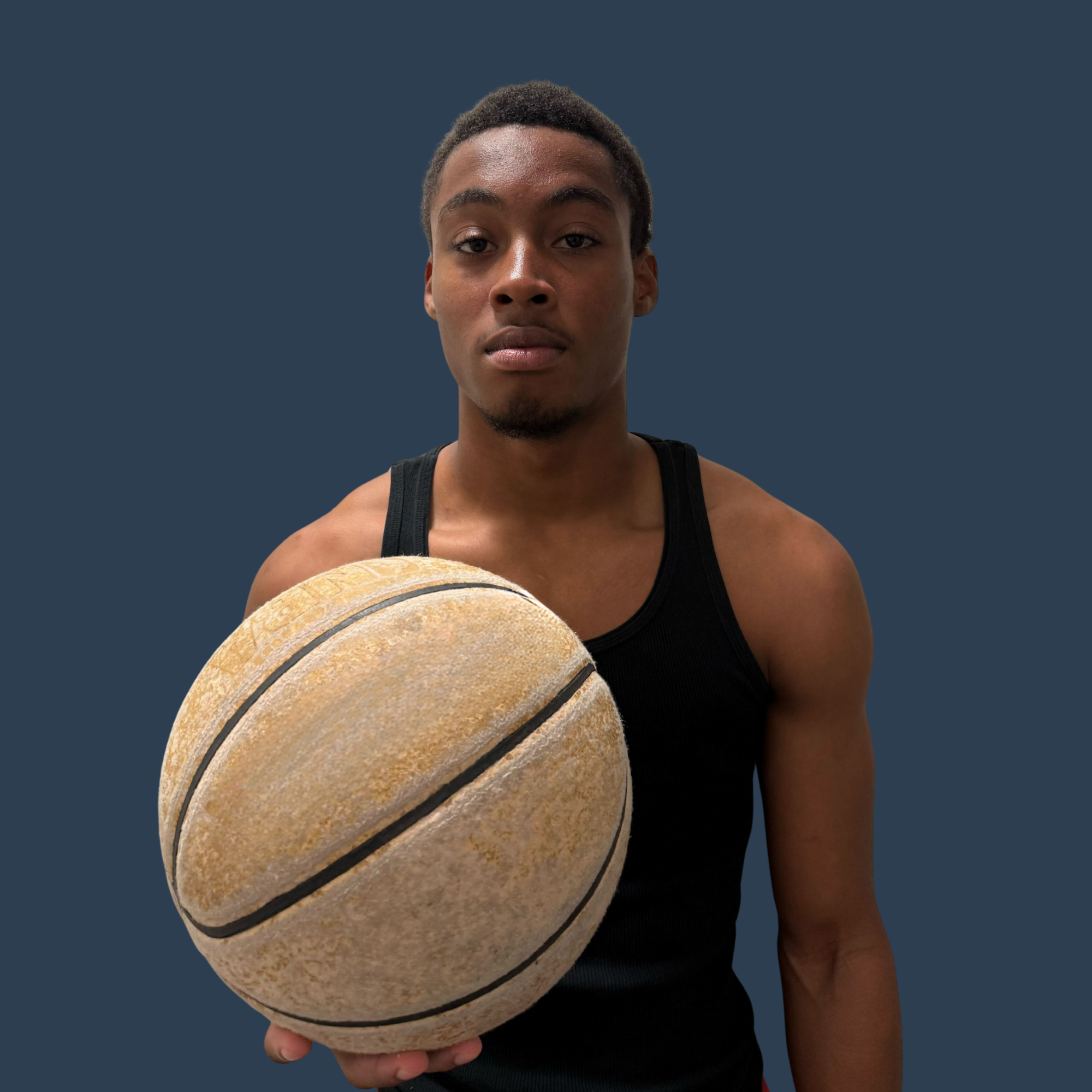 Aaron Frugé HOOPTEQ intern holding a basketball