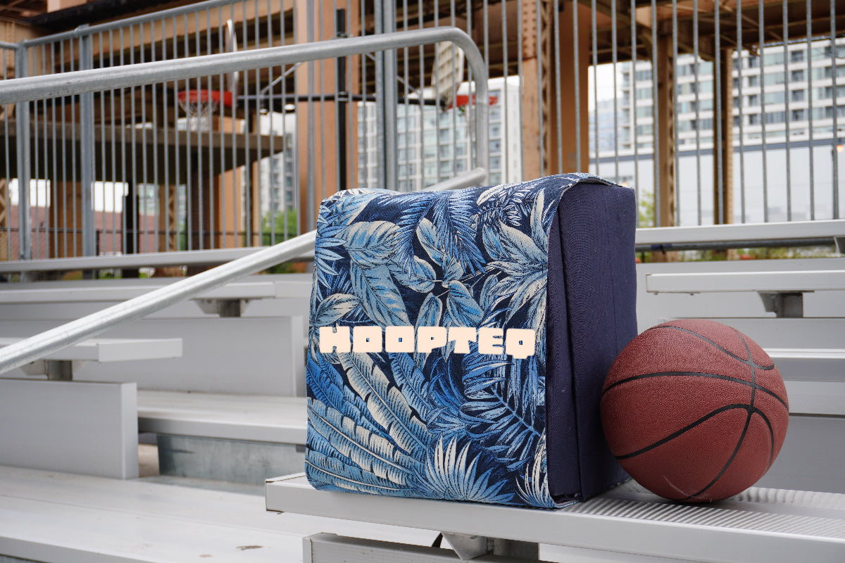 Pattern blue HOOPTEQ backpack with colored skin next to basketball on court