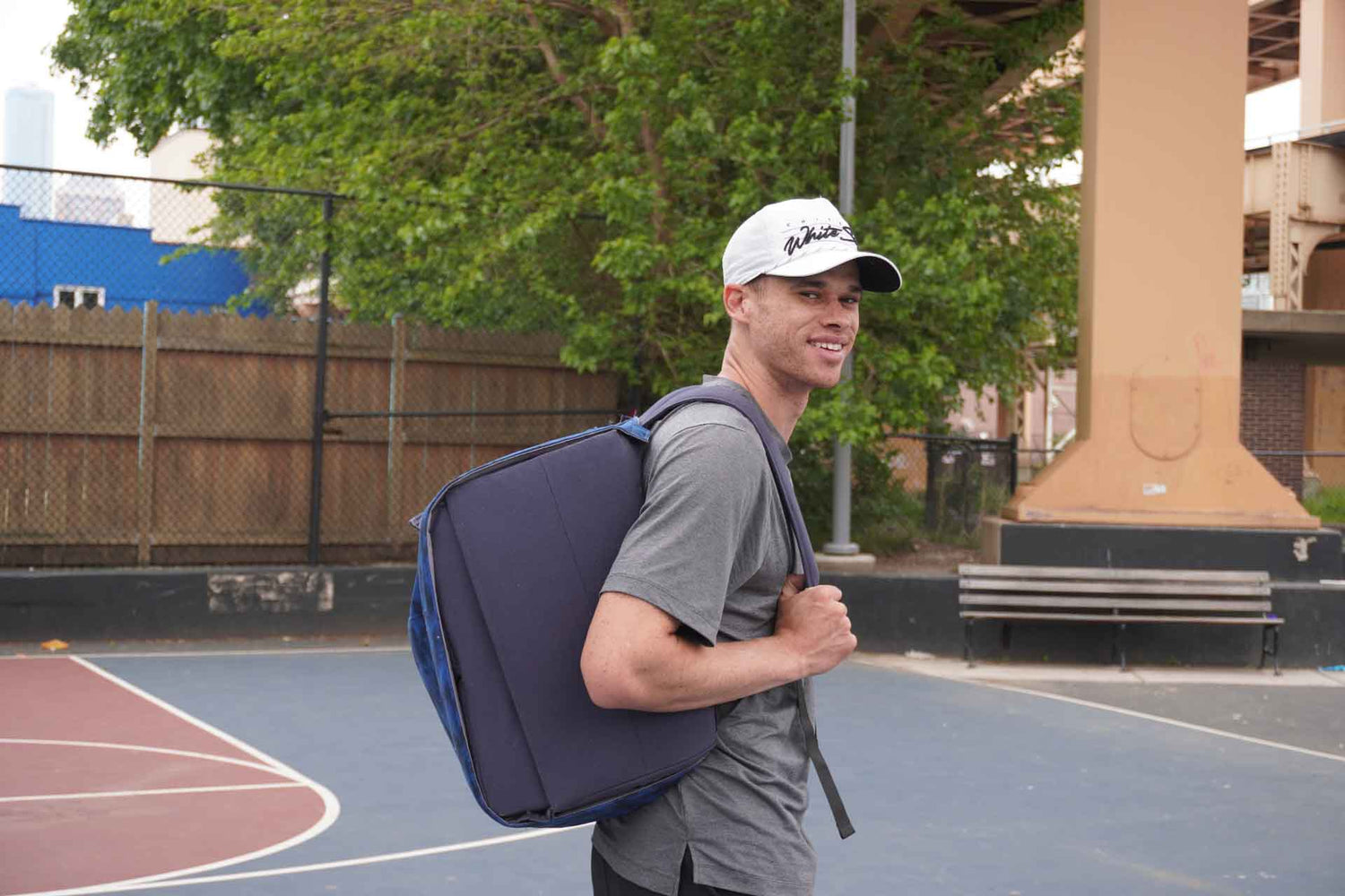 Founder Eric Roberson with HOOPTEQ on his back, smiling in a side profile shot.