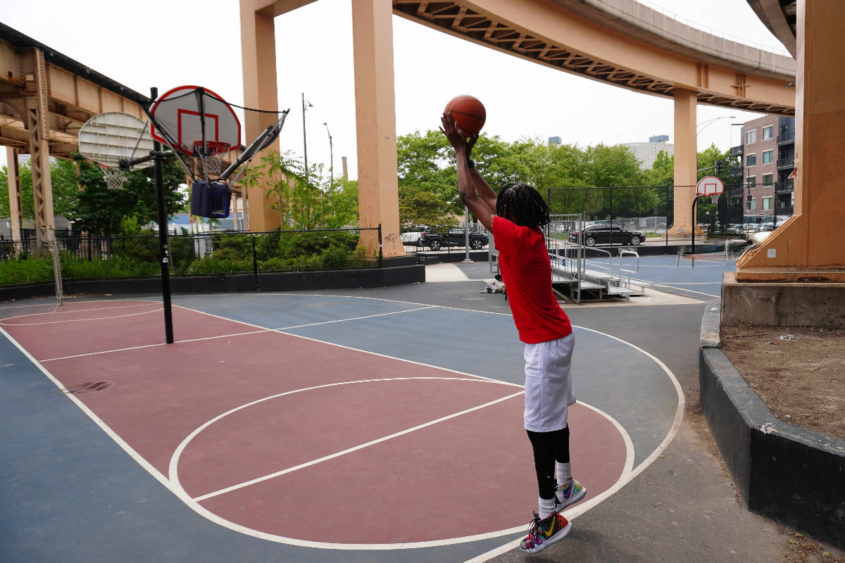 Young basketball player using HOOPTEQ for shooting drills